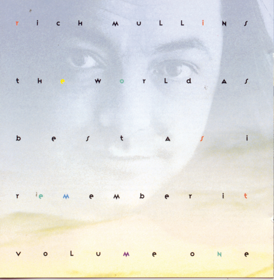 Album Art of Rich Mullins's The World As Best As I Remember It, Vol. 1 album - The background looks like a gradient of a clear sky, a powdery blue at the top and a yellow gold at the bottom. Layered on top of this is a transparent, black-and-white photo of a middle-aged white man with long, black hair, zoomed in close on just his face. And on top of all that, spread out across five lines and spaced across horizontally as well are small letters that spell out the artist's name in the first line and the album title on the next four lines. Most of the letters are black in color, but some are other primary colors.