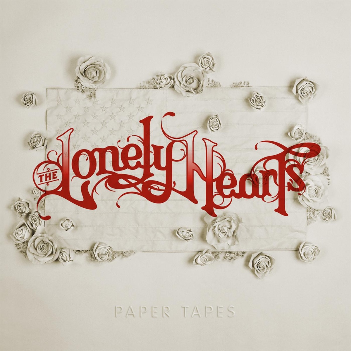 Album Art of The Lonely Hearts's Paper Tapes album - A photo of a white piece of paper, and attached to the paper in the middle ia an embossed white paper American flag, with small roses and other flowers covering parts of the flag. Actually, maybe it's not all made of paper, but is made of something else and just all painted that same off-white color as the paper. Over the top of this is printed in red the band name in very large, decorative red text.</body></html>