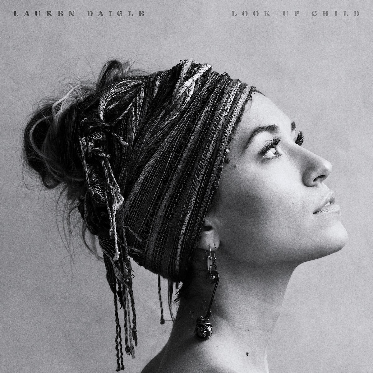 Album Art of Lauren Daigle's Look Up Child album - On a mottled gray background, a black and white photo of a woman from the shoulders up looking to the right an slightly up. The photo is mostly a profile angle, with just a bit of her left eyelash showing behind her nose. Her hair is up inside a cloth that is wrapped around the top and back of her head, covering most of her ears as well.</body></html>