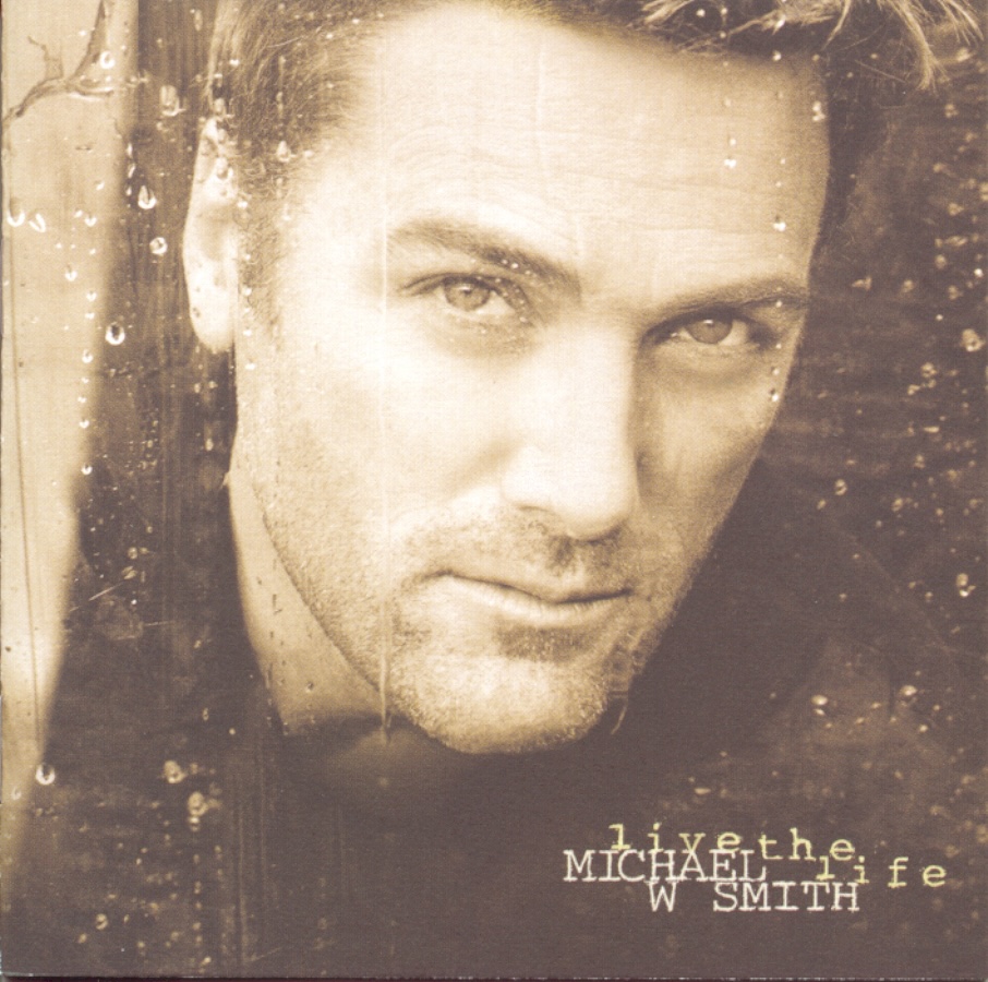 Album Art of Michael W. Smith's Live The Life album - A sepia-tone brown photo of a white man's face, looking through a window with raindrops on it. The man is looking at the camera and has a hint of a smile and his hair is short, and his beard and mustache are very short, mostly just a bit of fuzz.</body></html>