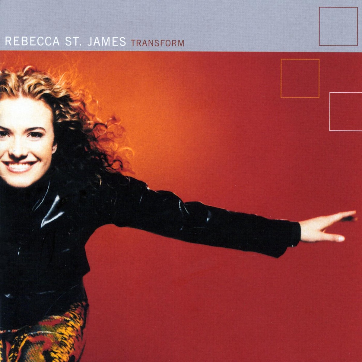 Album Art of Rebecca St. James's Transform album - On a bright red background with a more orange spot on the left, a white woman with curly brown hair is pictured off to the left, with the left edge of her head and body off the edge of the frame. She is wearing a shiny black jacket and colorful pants, and her left hand is outstretched off towards the right, kinda like she's flying. She has a bit smile and is looking at the camera. Above her head, at the top is a gray bar stretching across the top, with the artist name printed in white letters and the album name right after in smaller red letters. In the top right, there are also a few squares printed in various colors.