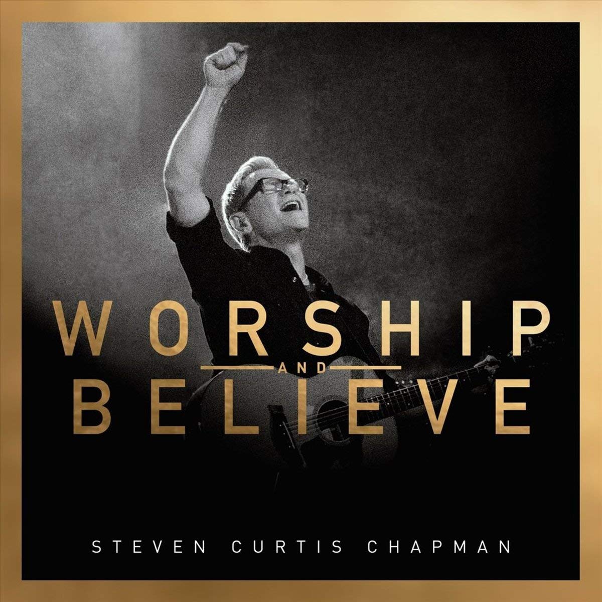 Album Art of Steven Curtis Chapman's Worship And Believe album - A somewhat grainy black-and-white photo of a middle-aged man standing holding a guitar and holding his right hand up in praise while looking upwards with his mouth open and eyes closed, maybe in the middle of singing. The man is lit but the background is mostly dark and is probably a hazy stage.</body></html>