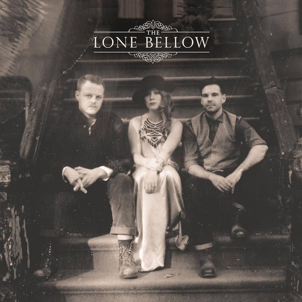 Album Art of The Lone Bellow's self-titled album - In a black-and-white photo, three white people are sitting on the front steps of a New York City brownstone, from the looks of it. On both the right and left are men wearing boots, the one on the left with lighter hair and a black shirt, and the one on the right with black hair and a grey shirt with vest and black pants. In the middle is a woman with probably brown hair coming down over her right shoulder.</body></html>