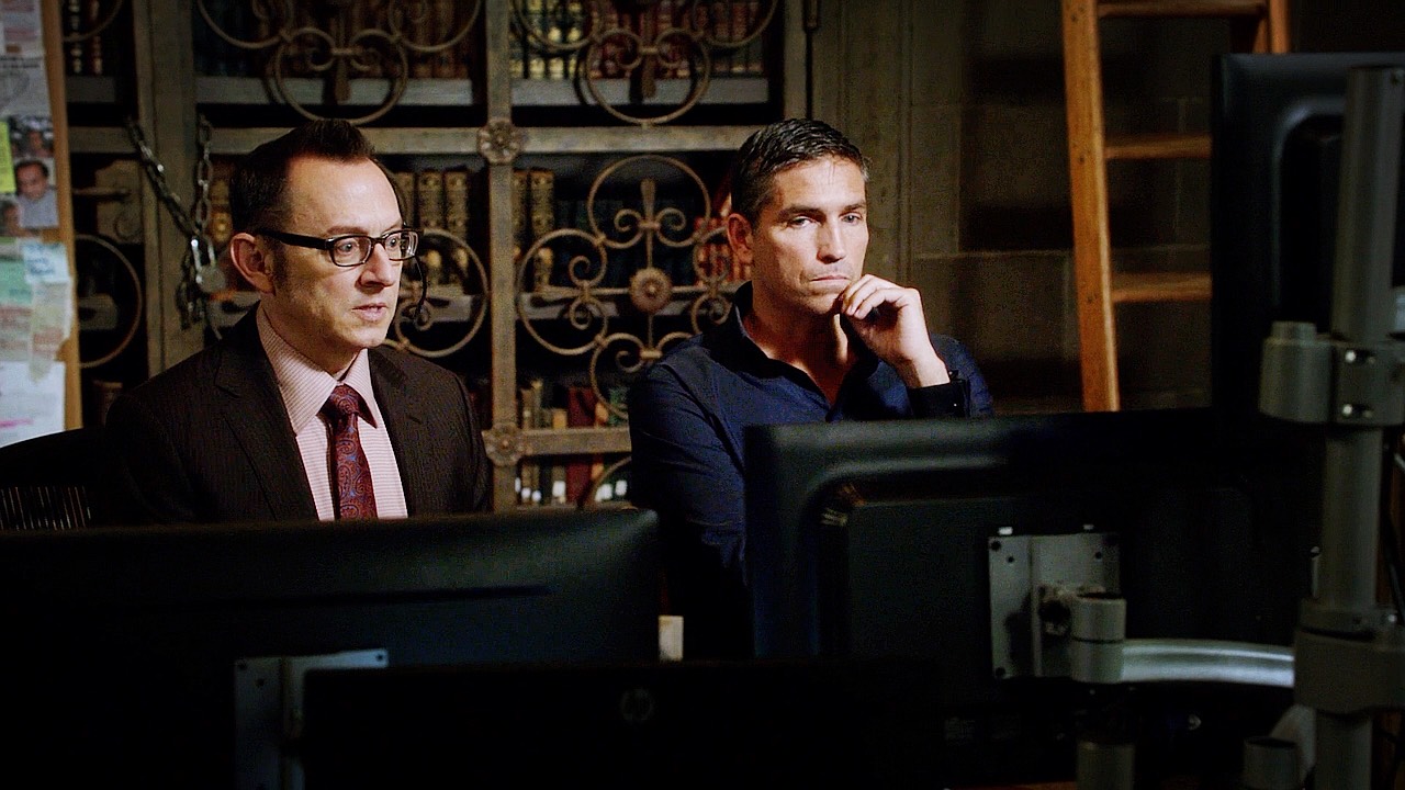 Photo of Reese and Finch at a bank of computer screens